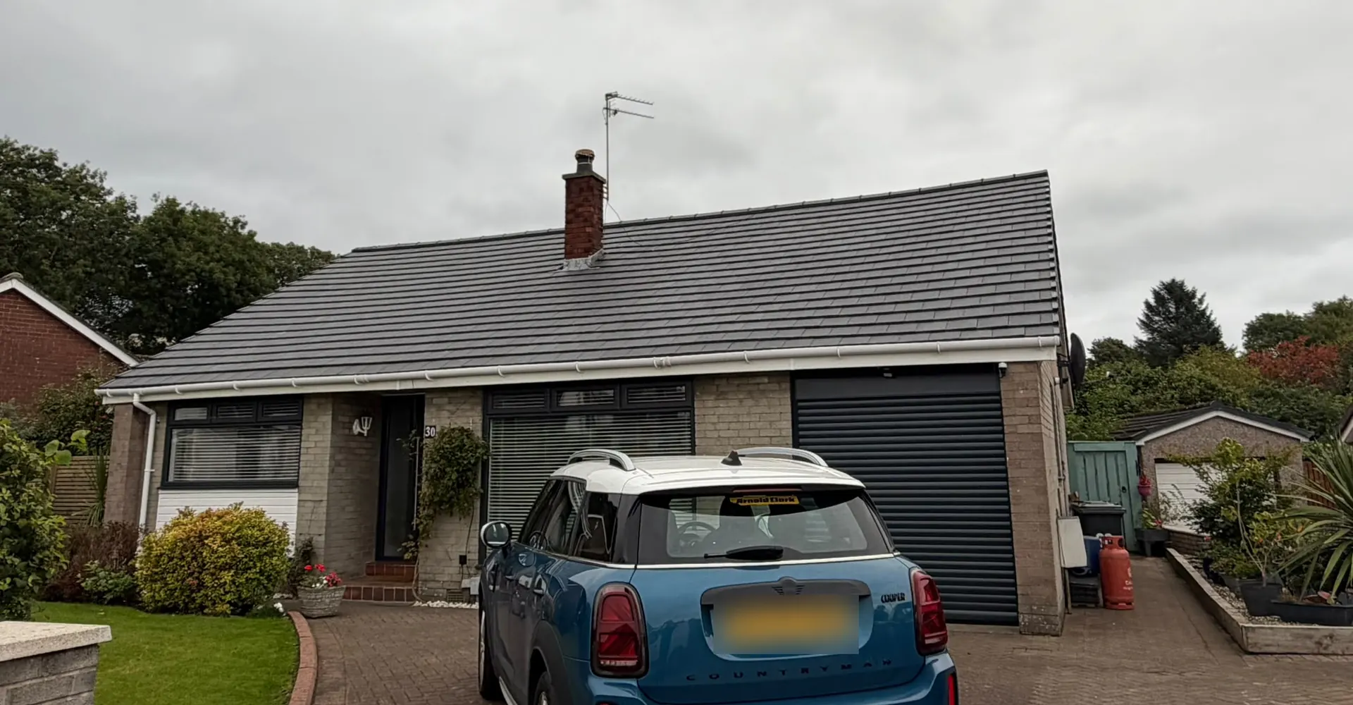 Bungalow re-roofed by Revive with new grey tiles and white guttering